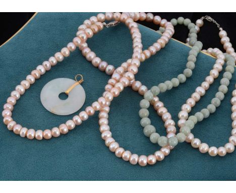 A Chinese Jade Disc pendant, with a yellow metal mount, 4.5cm by 3.5cm, a Chinese hardstone necklace, 22cm together, together