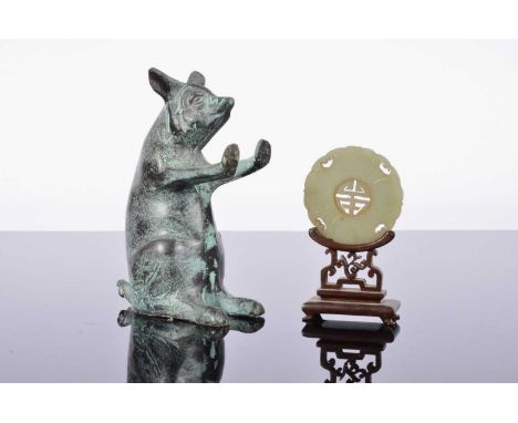 A bronzed figural bookend and a carved Chinese hardstone disc on hardwood stand, the pig or boar 14.5cm high (3)