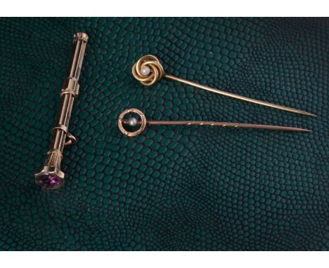 Two gold and seed pearl stick pins, 2.5g, and a gilt metal and red paste set propelling pencil, 6.8cm extended