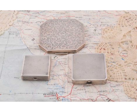 Three square silver compacts, Three square silver compacts, largest having scroll design and canted corners, marked 935, 7cm,