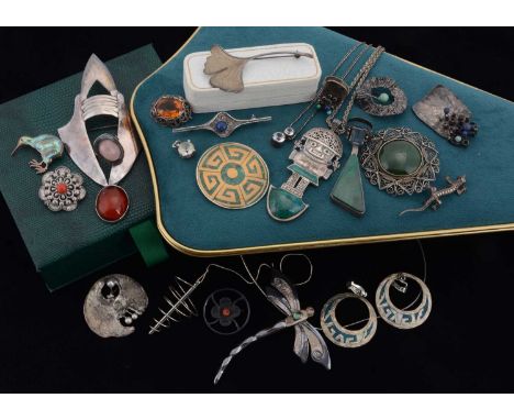 A collection of silver jewels, including a silver gem set dragonfly brooch, an Aztec silver and turquoise pendant, nephrite a