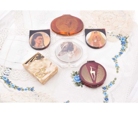 Two Frida Kahlo demi lune celluloid double mirrors, 7cm x 6cm, Orlane floral moulded plastic oval 10.5cm x 9cm, Dermetics hor