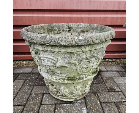 A reconstituted weathered stone round tapered garden planter with mask design, standing at 48cm tall, good condition with usu