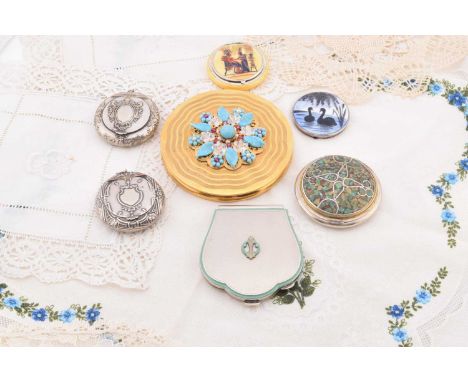 Continental compacts, including three Austrian comprising a gilt metal circular 1950s turquoise stone mounted example, 9cm di