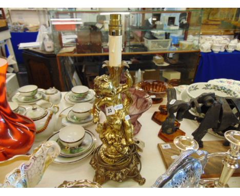 A gilt framed figural lamp