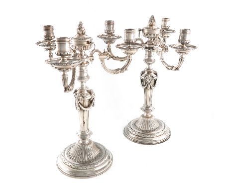 A pair of George III and Victorian silver three-light candelabra with associated branches, the bases by Parker and Wakelin, L