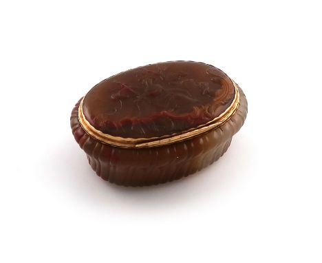 An 18th century gold-mounted carved agate snuff box, unmarked, probably German, oval form, the tapering sides with carved flu