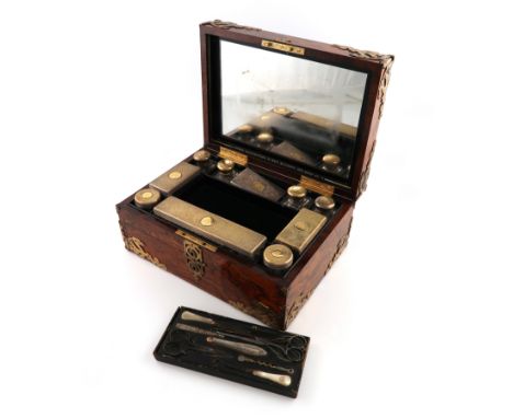 A Victorian silver-gilt mounted travelling dressing table set, the mounts by Brownett &amp; Rose, London 1860, retailed by As