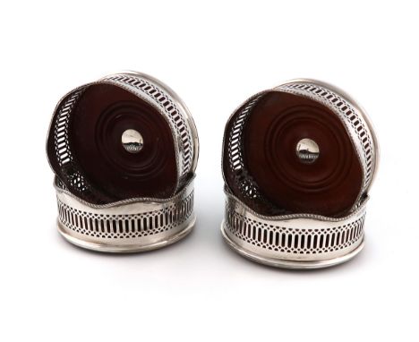 A set of four modern silver wine coasters, by R E Porter, Birmingham 1989, circular form, pierced with vertical slats, wavy-e