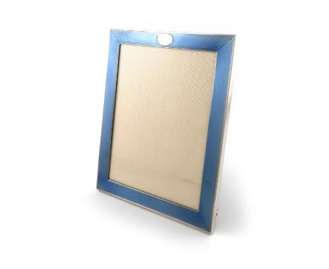 A silver and blue enamel photograph frame, by L. Emmanuel, Birmingham 1910, retailed by Finnegan's, upright rectangular form,
