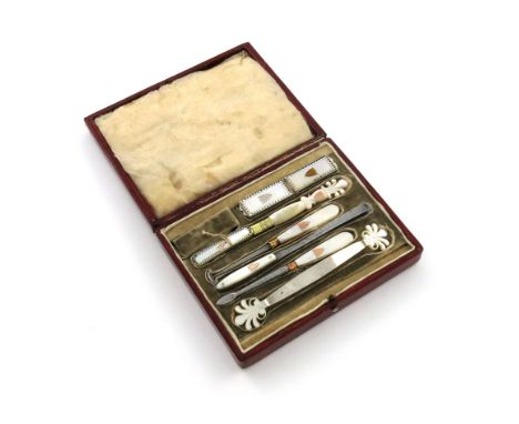 A 19th century French silver and silver-gilt mounted mother-of-pearl dental set, comprising: a silver-gilt toothbrush, with a