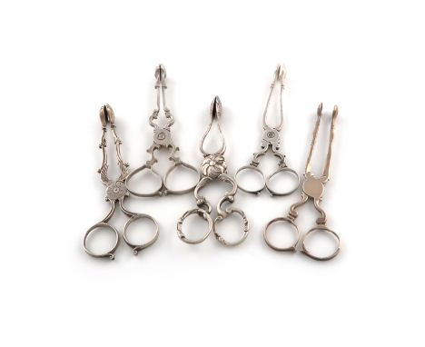 A collection of five pairs of 18th century silver sugar nips, comprising an Irish pair with shell bowls, scroll arms and ring