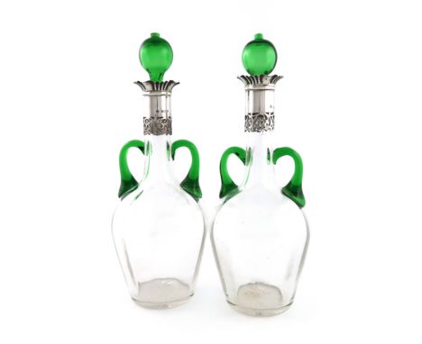 A pair of late-Victorian silver-mounted clear and green glass decanters, by William Hutton and Sons, Birmingham 1900, baluste