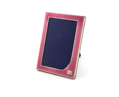 A silver and pink enamel photograph frame, by S M Levi Ltd, Birmingham 1932, upright rectangular form, the enamel on an engin