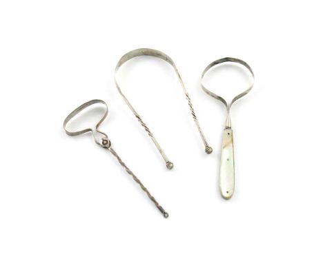 A small collection of three 19th century tongue scrapers, comprising: a Chinese one, with a twisted handle, a tong shaped one