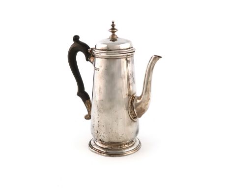 A silver coffee pot, by The Barnards, London 1910, tapering circular form, scroll handle, domed hinged cover with a knop fini