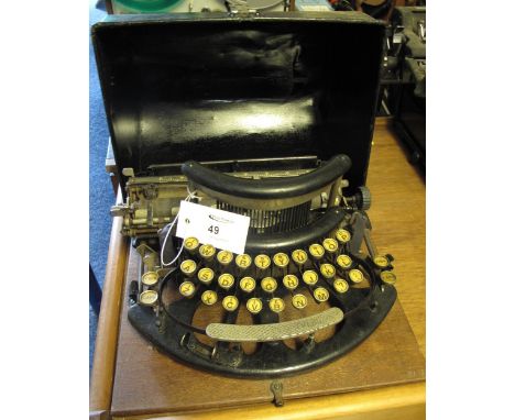 Early 20th Century Imperial model B typewriter in Japanned metal case. CONDITION REPORT: Tarnished/rusting in places. Leather