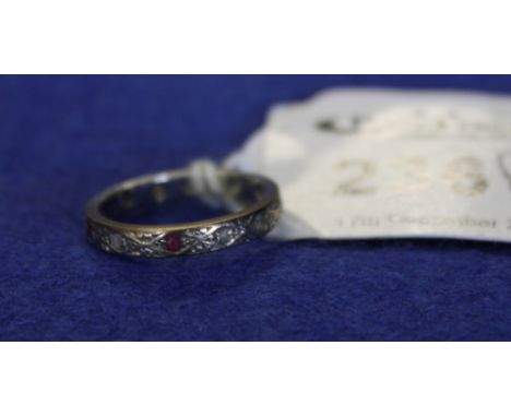 White metal eternity ring set with ruby and diamonds. 