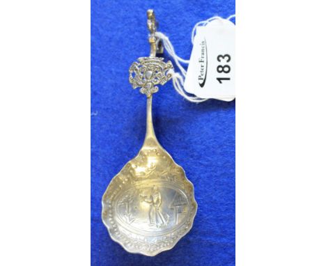 White metal, probably silver, tea caddy spoon decorated with figure and anchor in landscape with figural terminal, probably D