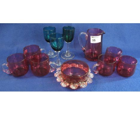 A group of assorted cranberry and other coloured glass items to include: wine glasses; cups; sucrier and jug.  (11)