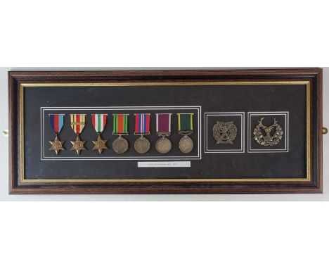 A framed display of Second World War medals, comprising 1939-45 Star, Africa Star with 1st Army Clasp, Italy Star, Defence Me