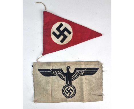 A German Third Reich triangular car pennant, 21cm long together with a German Army sports shirt eagle, 25cm wide and 14cm hig