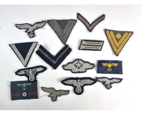 A group of German Third Reich cloth insigniacomprising a Heer Obergefreiter's rank chevron; an old-style field-grey Kriegsmar