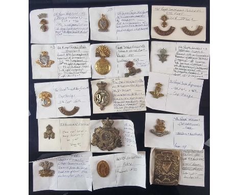 A collection of approximately 45 Army badges and buttons to include a Crimean War shoulder belt plate of the 18th Foot (Royal