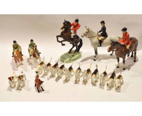 Beswick hunting group comprising two male hunstmen, one on rearing horse, further lady, two children on ponies plus a group o