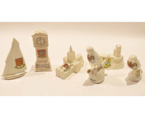Group of crested wares to include a yacht with the arms of Aylsham, clock with arms of Norwich, Cromer lighthouse with arms o