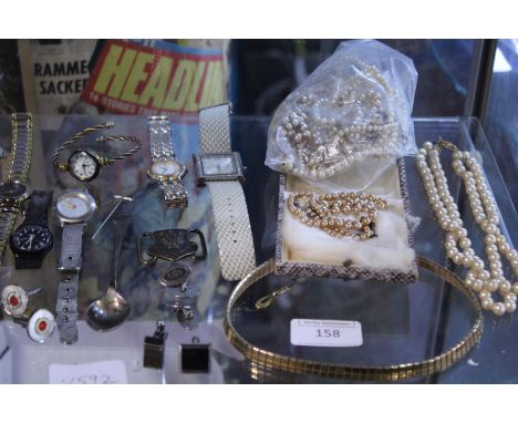 A shelf full of assorted costume jewellery and other 