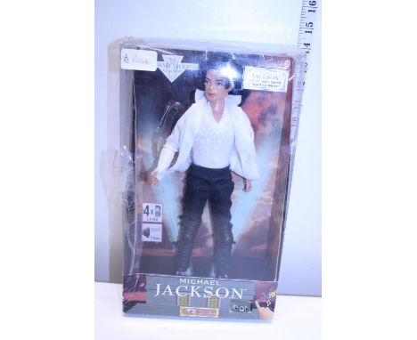 A boxed Michael Jackson figure (box damaged) 