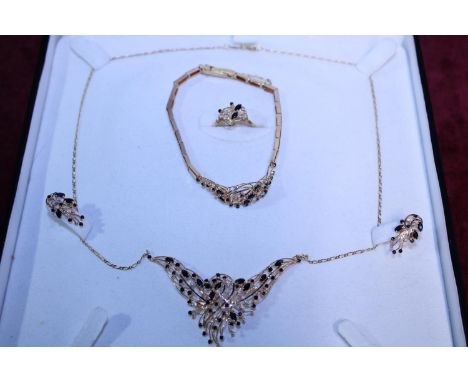 A 18ct gold wedding set, set with blue sapphires and diamonds consisting of necklace, bracelet, ring and earrings&nbsp;