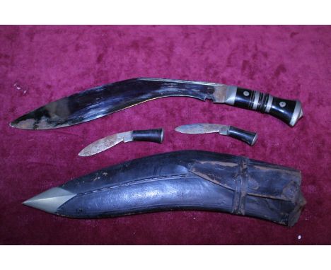 A vintage Kukri knife with scabbard and two smaller knifes a/f 