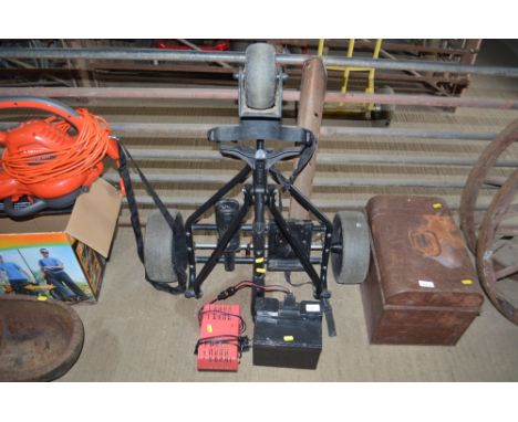 A Power Caddy golf trolley with Lucas battery and charger