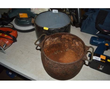 An enamel swing handled pot together with a cast iron twin handled pot