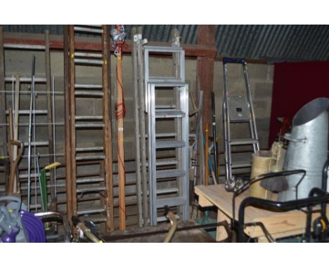 An aluminium extending ladder together with a wooden extending ladder