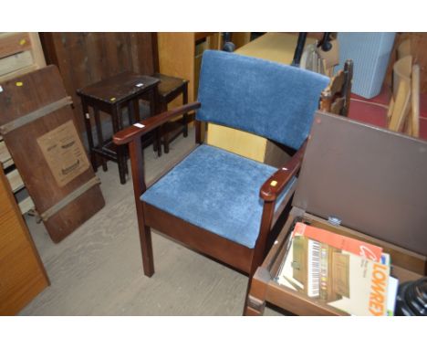A blue upholstered commode chair 