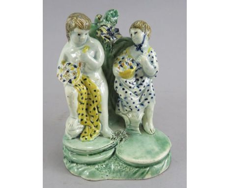 An early nineteenth century pearlware Staffordshire figure group of the flower gatherers, c. 1815. It is decorated in colours