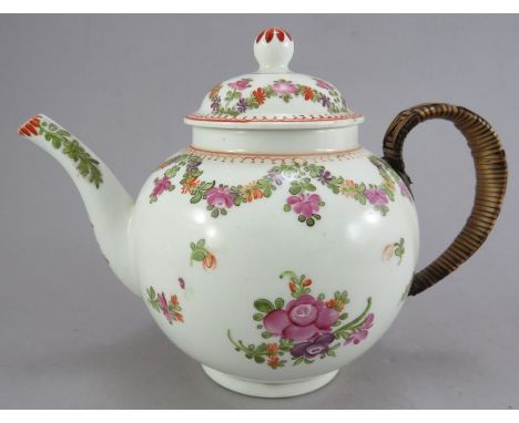 An eighteenth century Lowestoft hand-painted floral teapot and cover with make-do tinker handle, c. 1780-1800. It is painted 