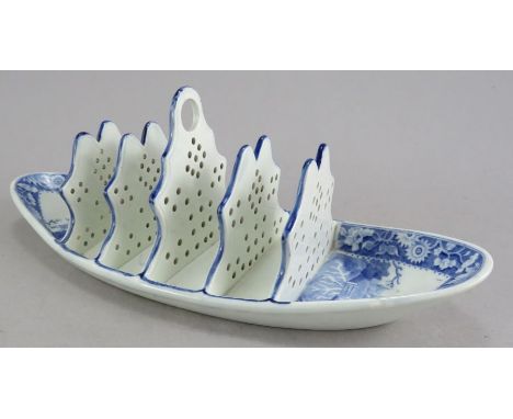 An early nineteenth century blue and white transfer-printed Spode Woodman pattern toast rack, c. 1825. It is marked to the un