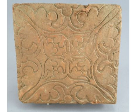 A German medieval floor tile from the fourteenth century. It is decorated with an impressed a geometric design. 22 cm wide. (
