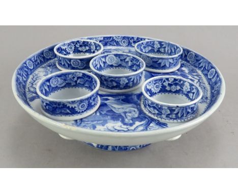 An early nineteenth century blue and white transfer-printed Spode Woodman pattern egg stand complete with all five egg cups, 