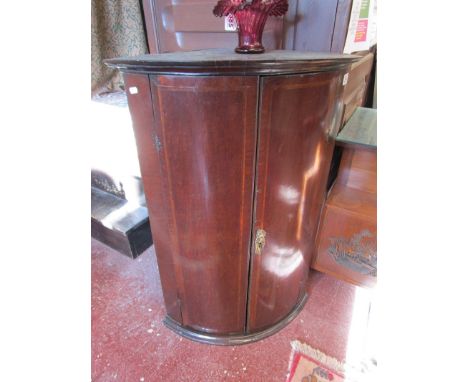 Early inlaid mahogany bow fronted corner cupboard