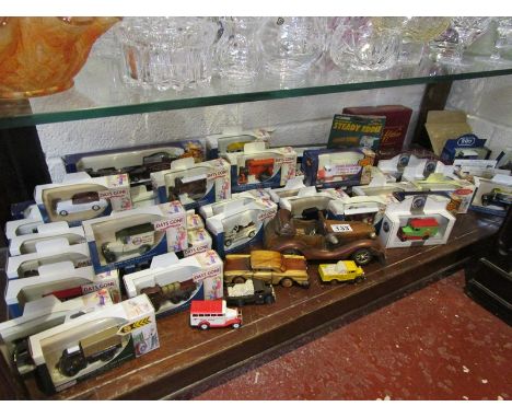 Shelf of diecast advertising vehicles - mostly boxed and 2 wooden model cars
