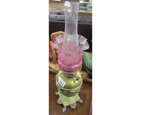 Brass oil lamp with Cranberry glass shade.Condition report: The glass shade is in good condition with no damage. It does have