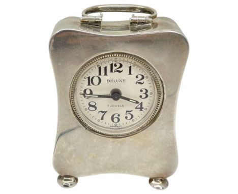 Small Silver carriage Clock. Birmingham 1911, E.F.Braham Ltd.
Stands on 4 pad feet. Velvet back opens to reveal windng mechan