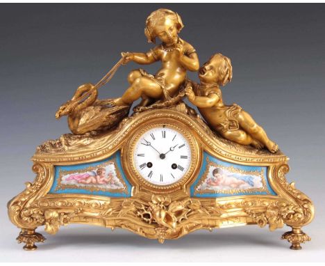 A LATE 19TH CENTURY FRENCH ORMOLU AND PORCELAIN PANELLED FIGURAL MANTEL CLOCK surmounted by a classical boy and girl with swa
