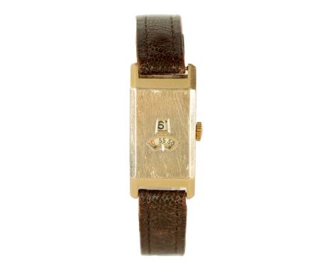 A 1920’s JUMPING HOUR 9CT GOLD WRIST WATCH on later leather strap, the rectangular case with hinged back, hour and minute ape