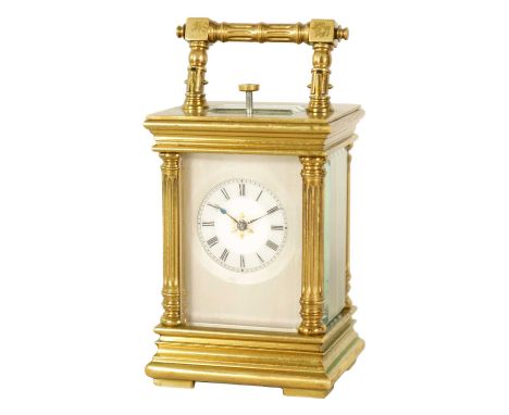 AN EARLY 20TH CENTURY SWISS MINUTE REPEATING MINIATURE CARRIAGE TIMEPIECE the brass case with reeded corner columns and bevel